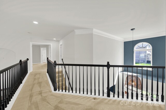 hall with recessed lighting, an upstairs landing, light colored carpet, and ornamental molding