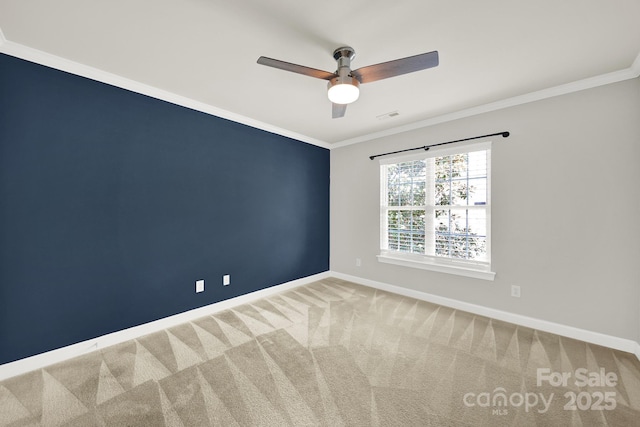 unfurnished room featuring crown molding, carpet, baseboards, and ceiling fan