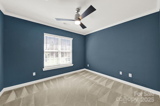 unfurnished room featuring visible vents, baseboards, crown molding, and carpet