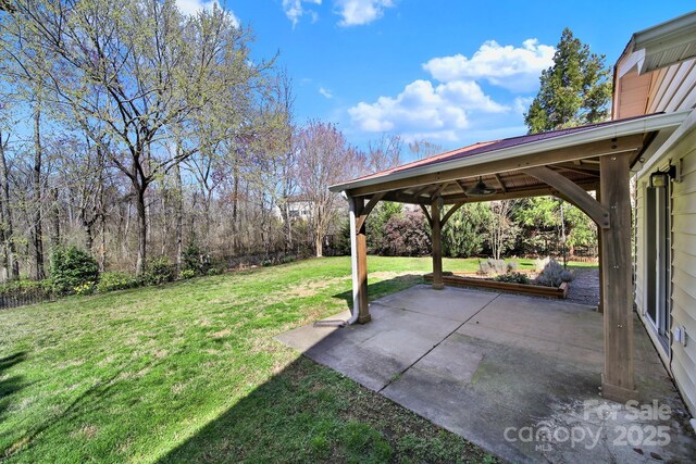 view of yard with a ceiling fan, a gazebo, and a patio area