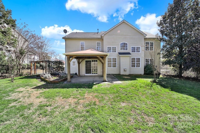 rear view of house featuring a yard, fence, and a patio area