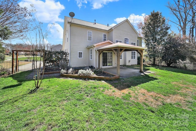 rear view of property featuring a patio, a lawn, and a fenced backyard