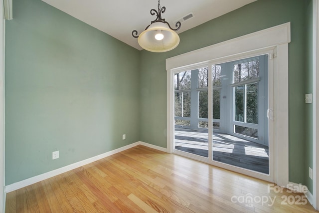 interior space with light wood finished floors and baseboards