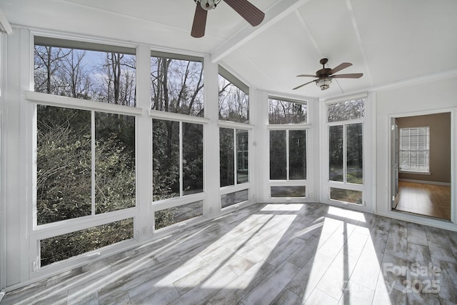 unfurnished sunroom featuring vaulted ceiling with beams and ceiling fan