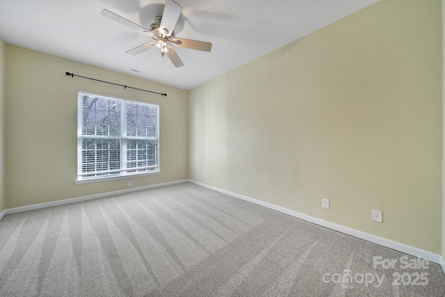 unfurnished room featuring carpet floors, baseboards, and a ceiling fan