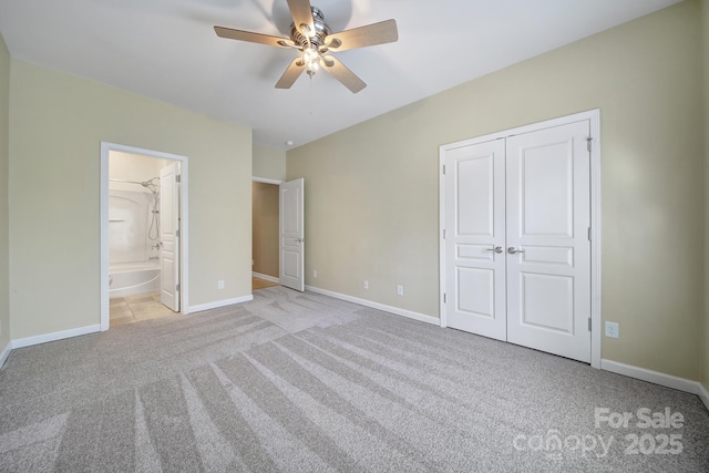 unfurnished bedroom with connected bathroom, baseboards, a closet, and light colored carpet