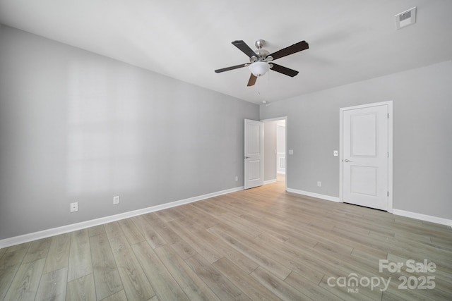 unfurnished room with a ceiling fan, light wood-type flooring, visible vents, and baseboards