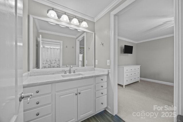 bathroom featuring ornamental molding, vanity, and baseboards