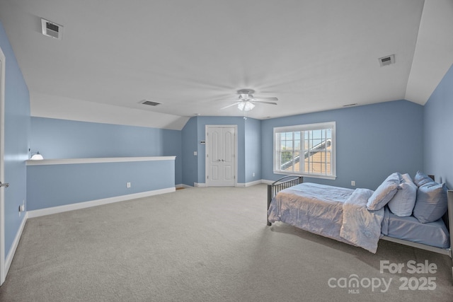 bedroom with vaulted ceiling, visible vents, and baseboards