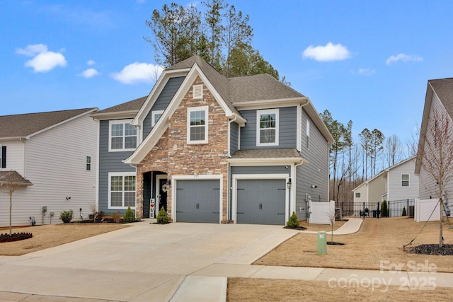 traditional home with a garage, a shingled roof, fence, driveway, and stone siding