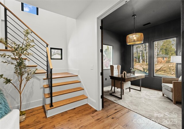 interior space featuring wood-type flooring, visible vents, and baseboards