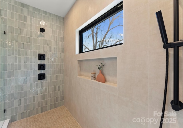 full bath with a tile shower