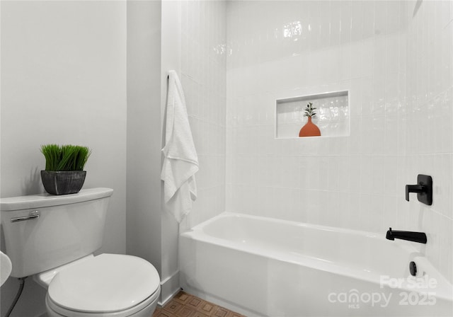 full bath featuring toilet and baseboards