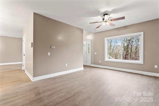 spare room featuring ceiling fan and light hardwood / wood-style flooring