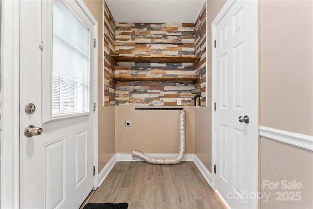 clothes washing area with hookup for an electric dryer and light wood-type flooring