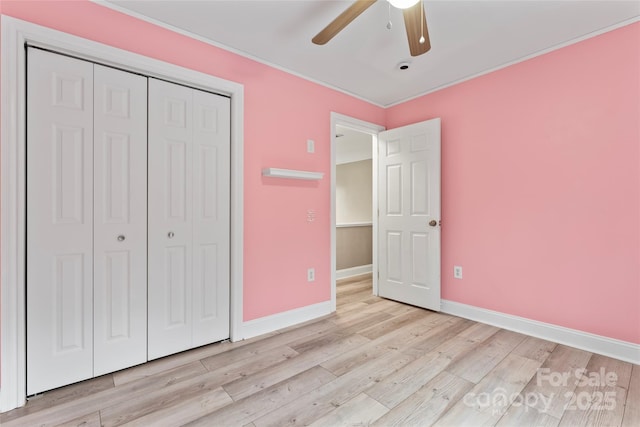 unfurnished bedroom featuring light hardwood / wood-style floors, a closet, and ceiling fan