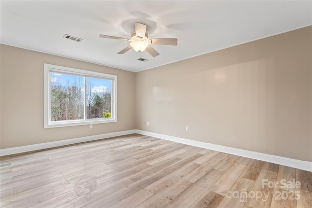 empty room featuring ceiling fan and light hardwood / wood-style floors