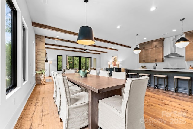 dining area featuring beamed ceiling, baseboards, recessed lighting, and light wood-style floors