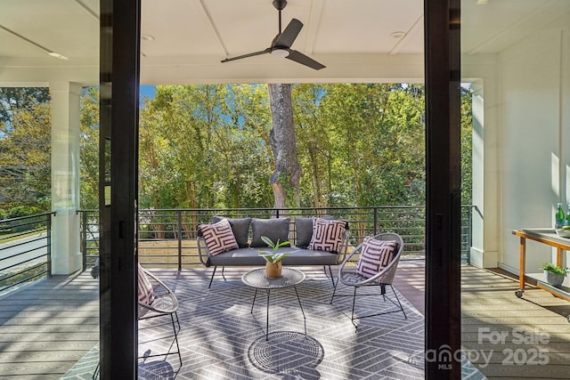 wooden deck featuring ceiling fan