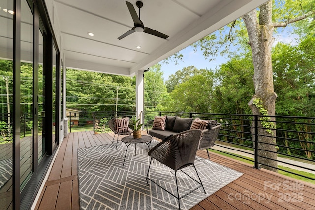 deck featuring ceiling fan and an outdoor living space