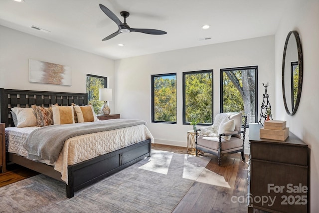 bedroom with baseboards, wood-type flooring, visible vents, and recessed lighting