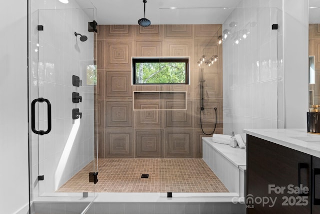 full bathroom with a shower stall and vanity