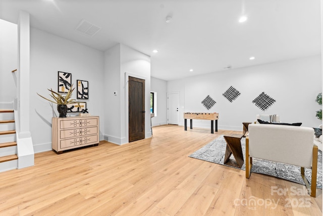 sitting room with baseboards, recessed lighting, stairway, visible vents, and hardwood / wood-style flooring