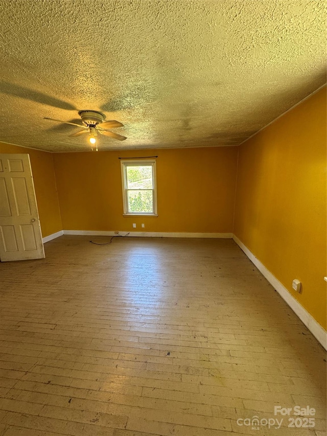 17 Jenny St, Asheville, NC 28806 - spare room with a textured ceiling, a ceiling fan, baseboards, and wood-type flooring