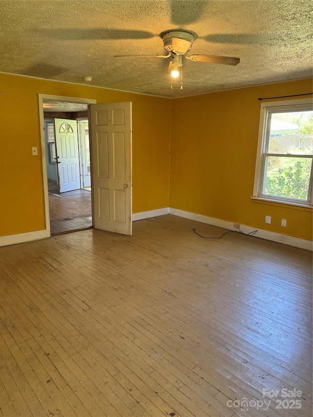 17 Jenny St, Asheville, NC 28806 - empty room featuring a textured ceiling, light wood finished floors, a ceiling fan, and baseboards