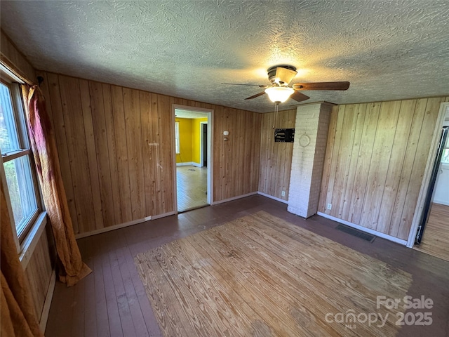 17 Jenny St, Asheville, NC 28806 - spare room with a textured ceiling, ceiling fan, hardwood / wood-style floors, wooden walls, and baseboards