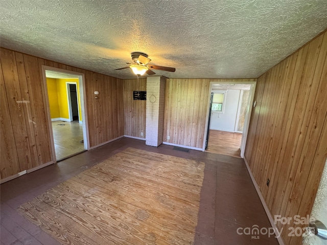 17 Jenny St, Asheville, NC 28806 - empty room with wooden walls, a ceiling fan, baseboards, and a textured ceiling