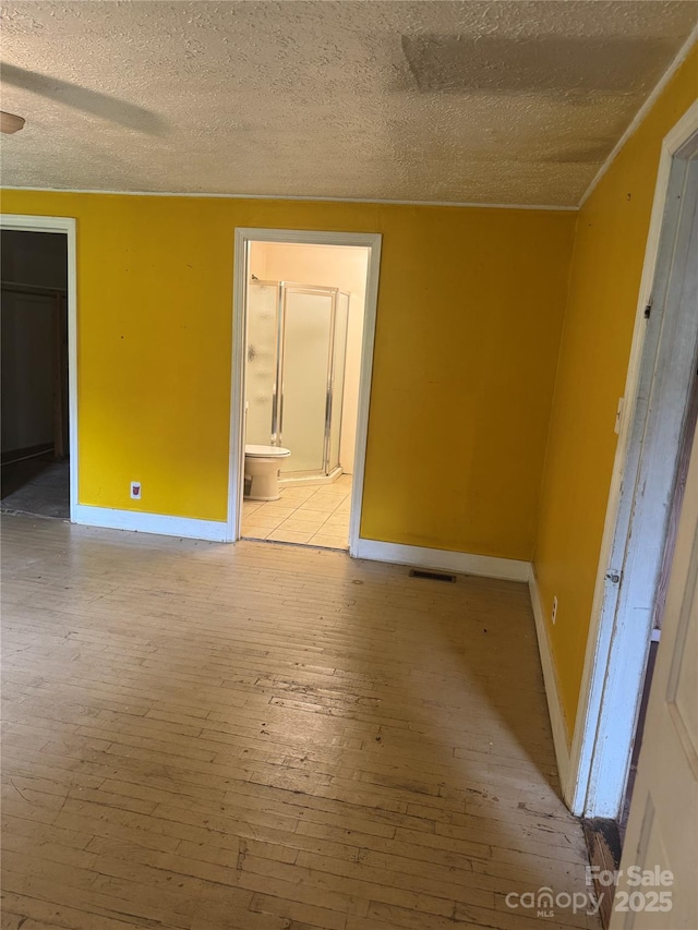 17 Jenny St, Asheville, NC 28806 - empty room with light wood-type flooring, baseboards, and a textured ceiling
