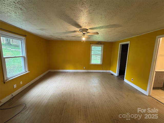 17 Jenny St, Asheville, NC 28806 - unfurnished room with baseboards, a ceiling fan, a textured ceiling, and light wood-style flooring