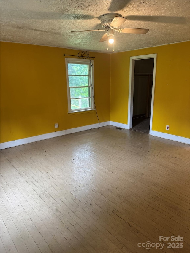 17 Jenny St, Asheville, NC 28806 - empty room with baseboards, ceiling fan, a textured ceiling, and hardwood / wood-style flooring