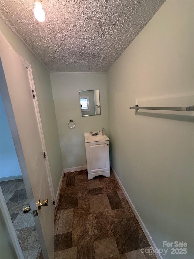 17 Jenny St, Asheville, NC 28806 - bathroom featuring vanity, baseboards, a textured ceiling, and stone finish floors