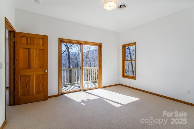 empty room with baseboards and light colored carpet