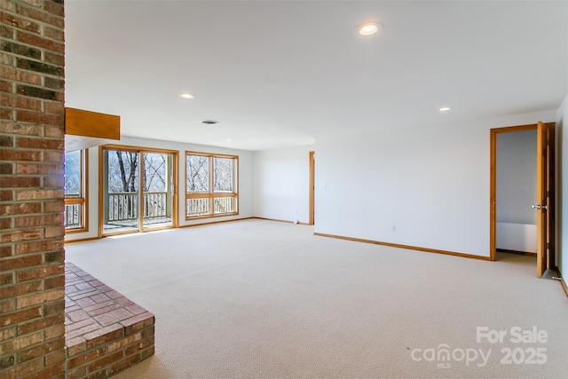 unfurnished living room with light carpet, baseboards, and recessed lighting