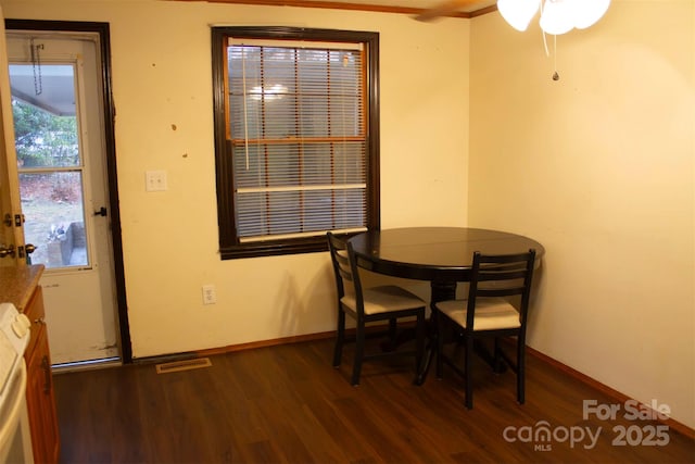 dining area with dark hardwood / wood-style flooring