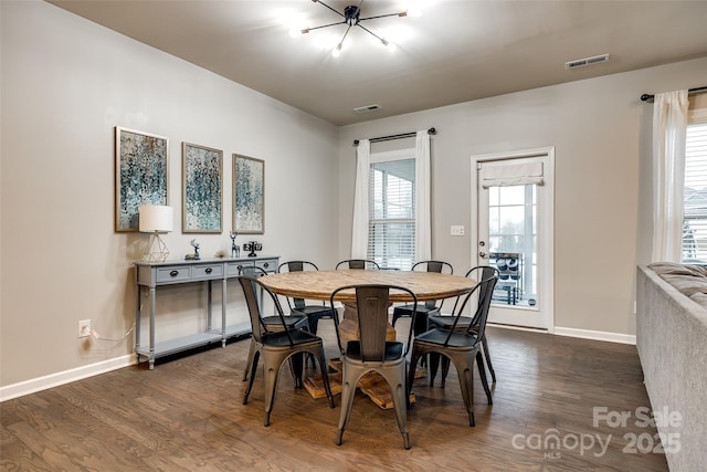 dining area featuring plenty of natural light, visible vents, and dark wood finished floors