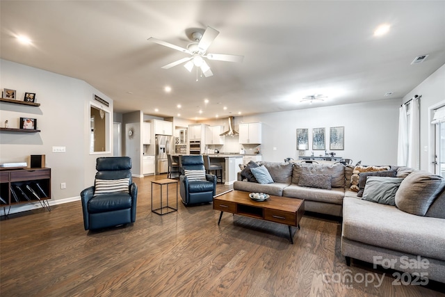 living area featuring baseboards, visible vents, dark wood finished floors, a ceiling fan, and recessed lighting