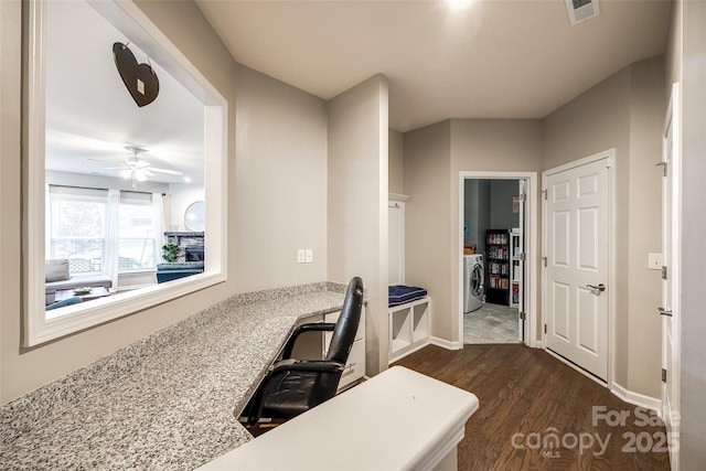 office area with visible vents, dark wood finished floors, baseboards, ceiling fan, and washer / clothes dryer