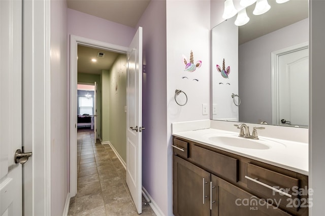 bathroom with visible vents, baseboards, and vanity