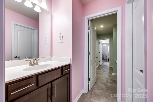 bathroom featuring baseboards and vanity