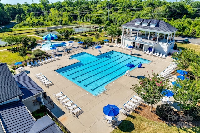 community pool with a patio area, fence, and a gazebo