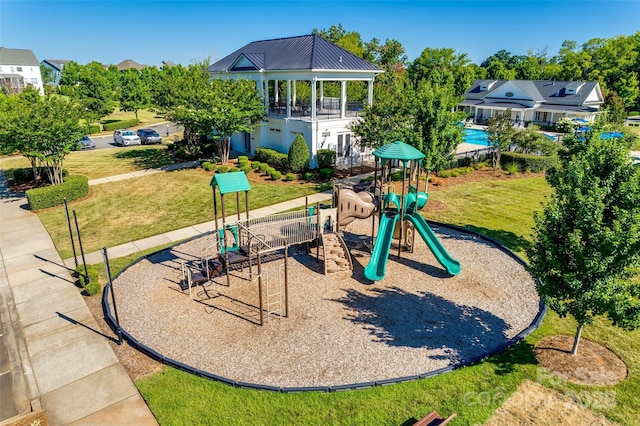 community jungle gym featuring a yard