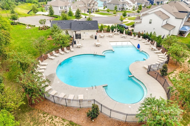 pool with a residential view, fence, and a patio