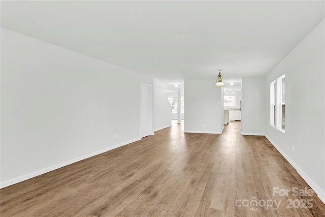 unfurnished living room with wood-type flooring