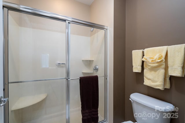 bathroom featuring toilet and walk in shower