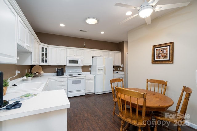 kitchen with dark hardwood / wood-style flooring, sink, white appliances, and white cabinets