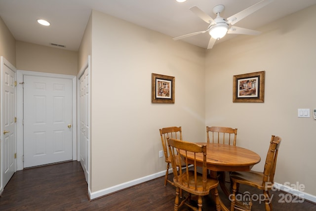 dining space with ceiling fan and dark hardwood / wood-style floors